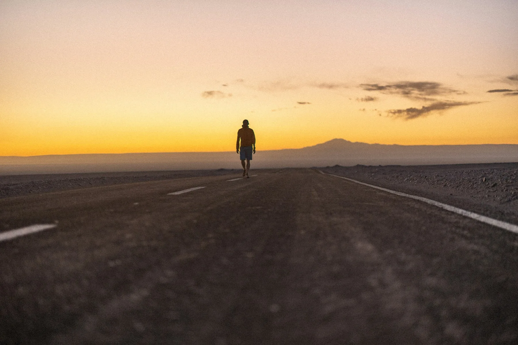 A person walking through an open alpine landscape